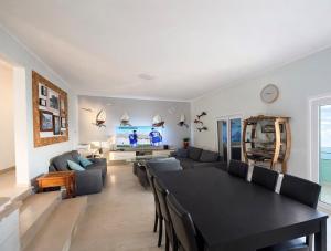 a living room with a black table and chairs at Apartments Vila Vino in Sveta Nedelja