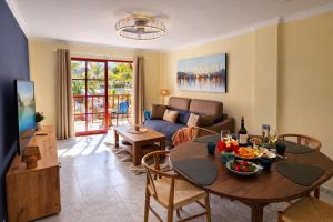 a living room with a table and a couch at Sunny Playa del Cura in Playa del Cura