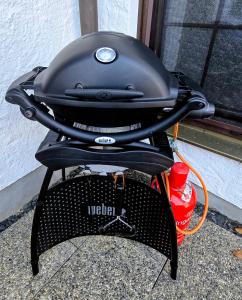 a grill sitting next to a red fire hydrant at Ferienapartment Opitz - Zugspitzregion in Ohlstadt