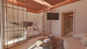a living room with a couch and a tv at Fahana Triana 54 Adults Only in Las Palmas de Gran Canaria