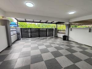 a large empty room with a checkered floor at ipohbnb Bercham HomeStay in Ipoh