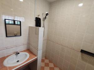 a bathroom with a sink and a mirror at ipohbnb Bercham HomeStay in Ipoh +15 photos