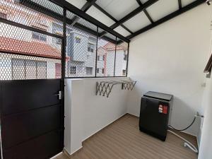 a garage with a basketball hoop and a door at ipohbnb Bercham HomeStay in Ipoh