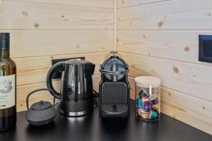a coffeemaker sitting on a counter next to a bottle of wine at Tirol Cabin by ALPAMI in Wildermieming