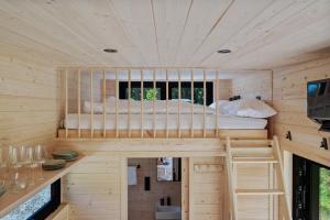 a bedroom in a tree house with a bunk bed at Tirol Cabin by ALPAMI in Wildermieming +24 photos