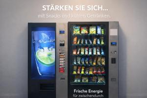 a vending machine with soda and drinks in it at Evermore Nürnberg - Fürth in Fürth