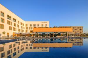 a hotel with a pool in front of a building at mk hotel tirana in Tirana