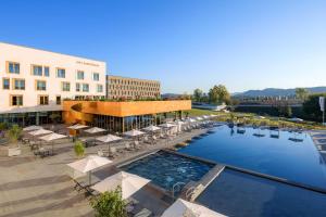 a hotel with a pool and tables and chairs at mk hotel tirana in Tirana