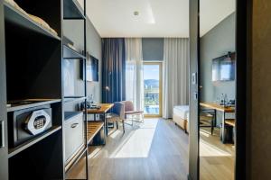 a hotel room with a bed and a dining room at mk hotel tirana in Tirana