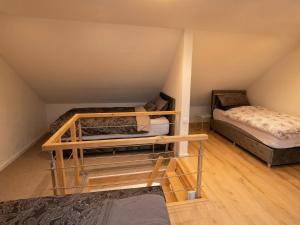 a room with two bunk beds in a attic at Grenz-Apartment an der Aach in Rielasingen-Worblingen