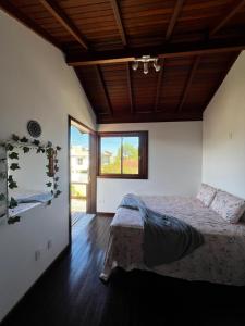 a bedroom with a bed and a large window at Casa Vibra Luz Guest House Familiar in Campeche
