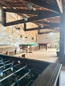 a ping pong room with two ping pong tables at Pousada Solar dos Guarás in Catas Altas +22 photos