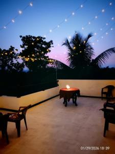 a table with a candle on top of a patio at The Paddy Breeze Villa in Marukwatura