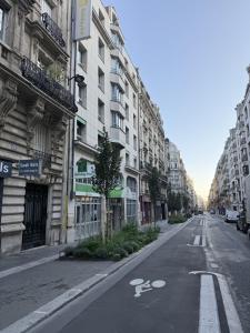 an empty street in a city with tall buildings at Holiday Inn Paris Montmartre by IHG in Paris