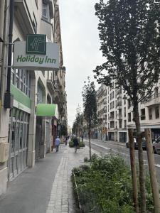 a street with a sign for a holiday inn at Holiday Inn Paris Montmartre by IHG in Paris