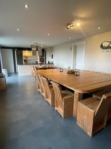 a large wooden table and chairs in a room at De Peelrand Hoeve in Venhorst