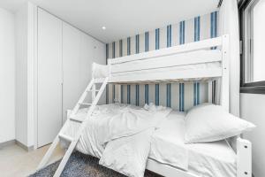 a white bunk bed in a white bedroom at Villa de lujo con jacuzzi, cine, billar y futbolín in Murcia +18 photos