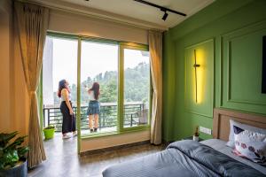 two women standing in a bedroom looking out the window at PACK Dharamkot in McLeod Ganj +53 photos