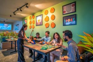 a group of people sitting around a table playing a game at PACK Dharamkot in McLeod Ganj