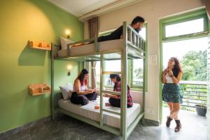 a group of people sitting on a bunk bed at PACK Dharamkot in McLeod Ganj
