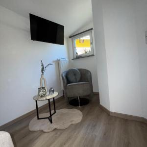 a living room with a chair and a table at Tiny Haus in Bad Sulza