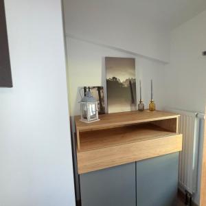 a room with a wooden shelf with a lamp on it at Tiny Haus in Bad Sulza