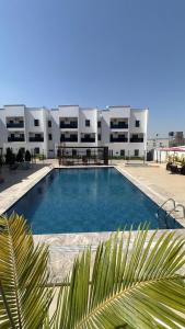 a swimming pool in front of a large building at Residence 541 Apartments and Suites in Abuja