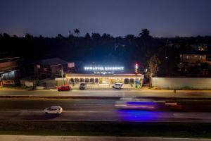 a police car driving down a street at night at Emmanuel Residency in Edappally