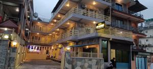 a building with balconies on the side of it at Hotel Lake shadow inn in Pokhara