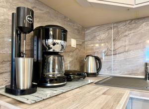 a kitchen with a coffee maker on a counter at Eunoia Homestay & BnB - Loutra Pozar, Aridaia in Aridaia +22 photos