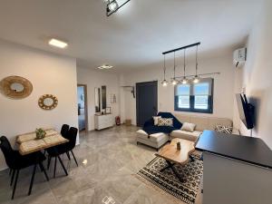 a living room with a couch and a table at Eunoia Homestay & BnB - Loutra Pozar, Aridaia in Aridaia