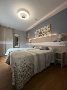 a bedroom with two beds and a large bed at Hotel Bahia in Gijón
