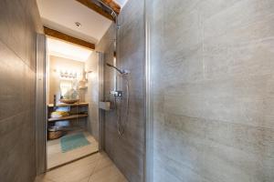 a shower with a glass door in a bathroom at Mas de Bubu in Châteaurenard