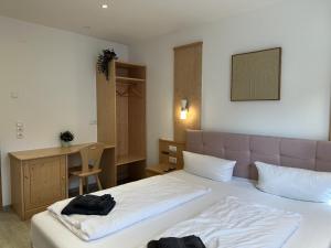 a hotel room with a bed and a desk and a desk at Gästehaus Ludwig in Rust +17 photos