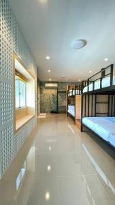 a room with two bunk beds and a hallway at Hideout Homestay in Ban Rai Pa Yoe