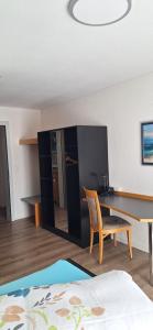 a room with a desk and a table and a chair at Gasthof Moosmatt in Egolzwil