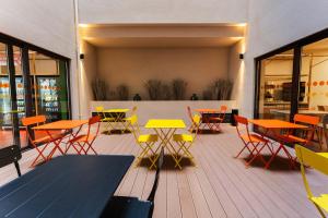 a group of tables and chairs on a patio at easyHotel Valencia Ciutat Vella in Valencia +64 photos