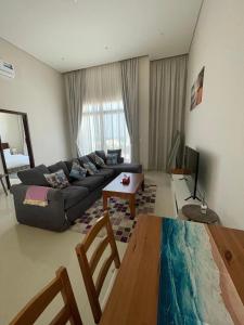a living room with a couch and a table at Hakuna Matata Villa - BF 515A in Muscat