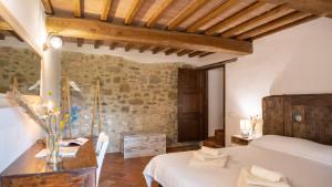 a bedroom with a bed and a desk in a room at Agriturismo L'Accolta in Tuoro sul Trasimeno