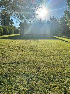 a house in a field with the sun shining at Departamento y aire libre in General Pico