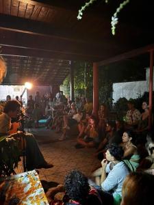 a group of people sitting in a crowd watching a presentation at Casa Vibra Luz Guest House Familiar in Campeche