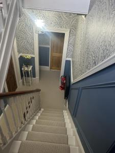 a stairway with blue and white wallpaper at The Welford in Harrogate