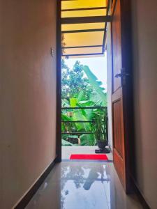 an open door with a view of a room at Banana Leaf Villa in Nikawatawana