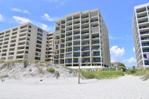 two tall buildings on the beach with a sandy beach in front at Direct Oceanfront Magic at Sea Marsh w Pool in Myrtle Beach