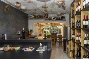 a tasting room with a bar with wine bottles at Robinson Danica 1 in Gornji Dingač