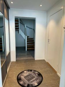 a hallway with a staircase and a rug on the floor at Trysil Central Villa in Trysil