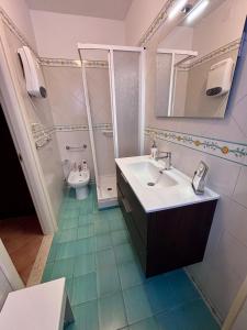 a bathroom with a sink and a toilet and a mirror at Duomo Square Apartment in Taormina