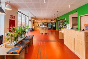 a store with green and orange walls and benches at easyHotel Valencia Ciutat Vella in Valencia