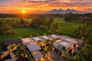 an aerial view of a house with a sunset at Subu Utamas Villas in Ubud