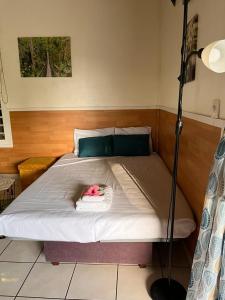 a bed with a stuffed animal on top of it at Bungalow Ludivine in Sainte-Anne